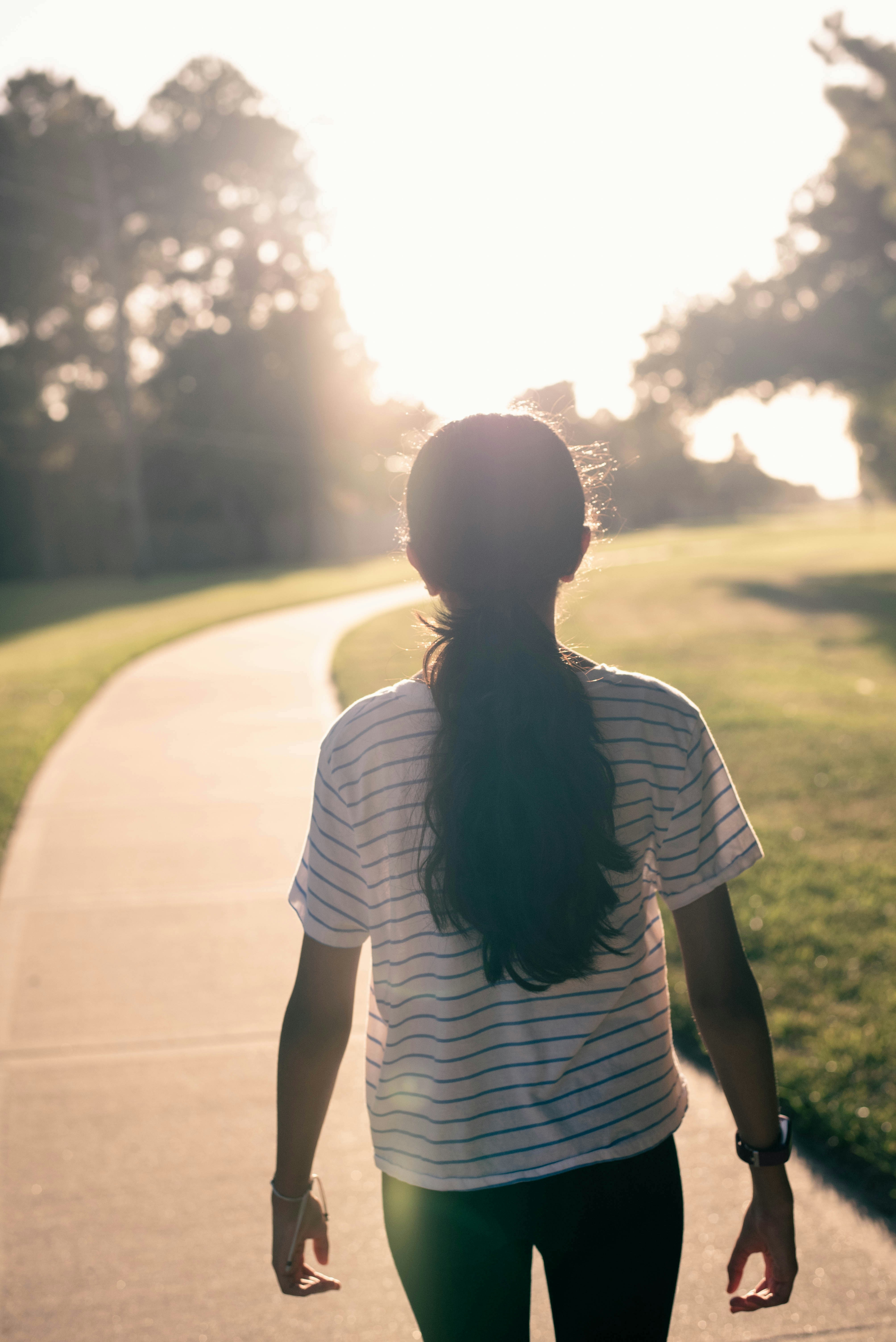 Woman walking along a path at sunrise representing God’s calling and living with purpose